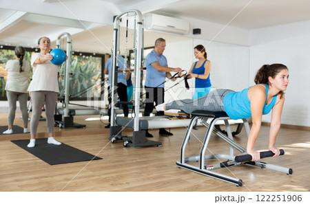 Young girl exercising on wunda chair in pilates studio Young girl exercising on wunda chair in pilates studio 122251906
