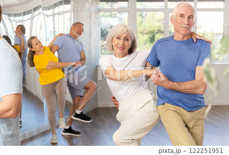 Cheerful elderly amateur couple dancing lindy hop at choreography class 122251951