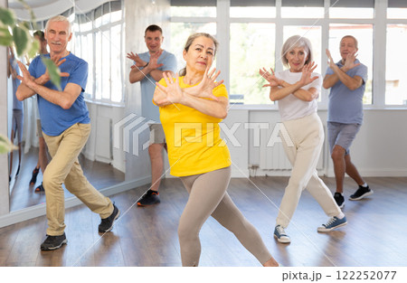 Elderly woman dances modern dances in group 122252077