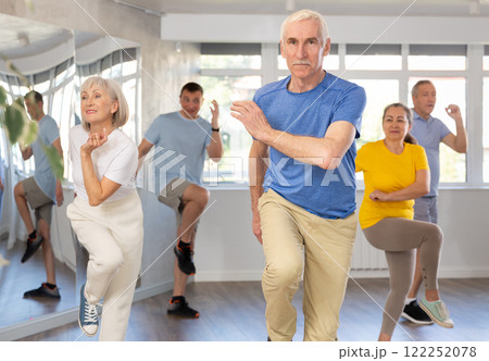 Elderly man learning dynamic dances at group choreography lesson Elderly man learning dynamic dances at group choreography lesson 122252078
