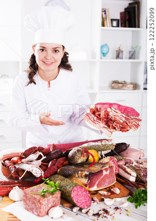 Cook woman with smoked products 122252099
