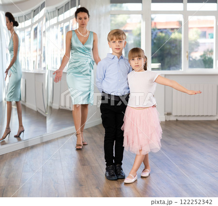 Boy and girl in pair train to dance contemporary vigorous hustle during classes. Boy and girl in pair train to dance contemporary vigorous hustle during classes. 122252342
