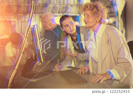 Kids and grandparents using computer in escape room Kids and grandparents using computer in escape room 122252433