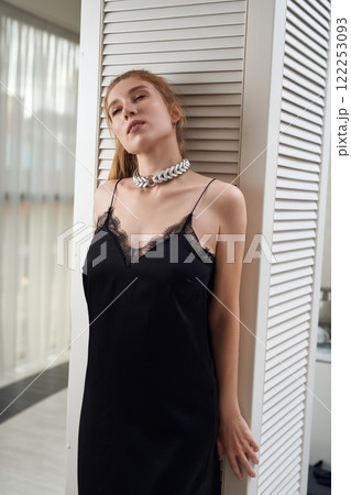 Stylish woman in elegant dress standing and collar 122253093