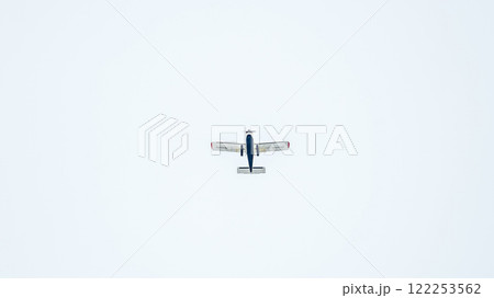 Small ultralight airplane with overhead wing and single propeller flying in sunset sky. 122253562