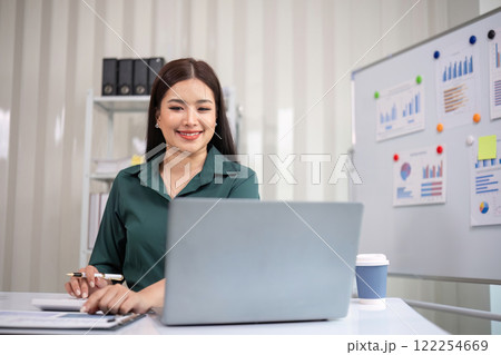 Beautiful business woman with determination Working on laptop in modern office 122254669