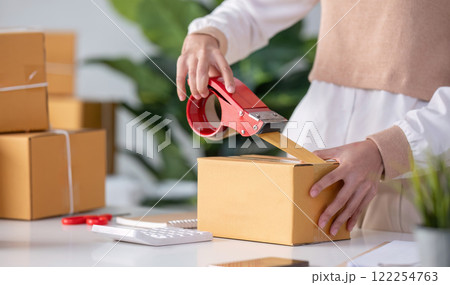 SME business entrepreneurs small in asia Preparing cardboard boxes in home office Small business operators preparing to ship to customers SME business entrepreneurs small in asia Preparing cardboard boxes in home office Small business operators preparing to ship to customers 122254763