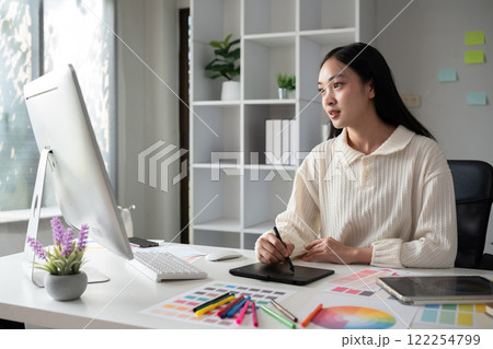 designer working in graphic design Choose colors for working with computers at your office desk 122254799