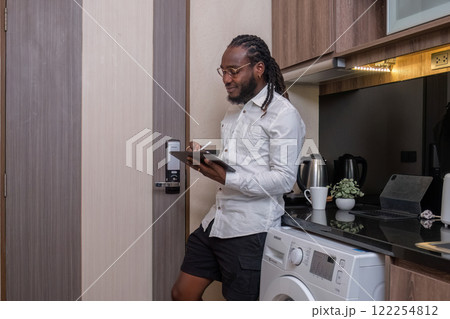 Young African American businessman dressed casually Work from your laptop while you're on vacation by working from home. Young African American businessman dressed casually Work from your laptop while you're on vacation by working from home. 122254812