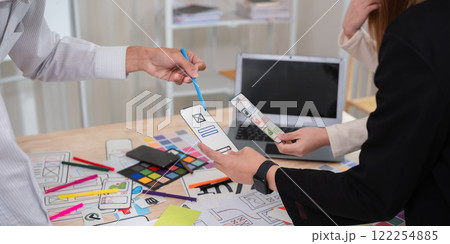 Application development team Meet together to brainstorm ideas for planning ux ui of the application for smartphones Application development team Meet together to brainstorm ideas for planning ux ui of the application for smartphones 122254885