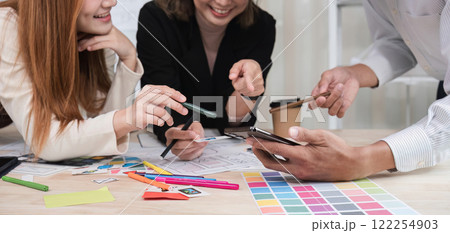 A team of Asian designers creates and designs UX Ui brainstorming software. A team of designers work together as a team in the office. 122254903