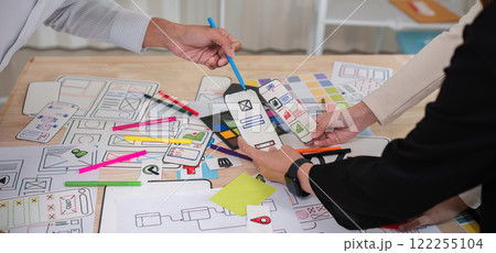 A team of Asian designers creates and designs UX Ui brainstorming software. A team of designers work together as a team in the office. 122255104