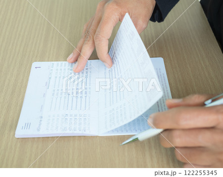 Hand holding Bank Account Book Statement Balance Number Cash, Hand Holding Data Investment Debt Math in Office, Bill Receipt and Payment Business Credit Card Account, Check Paper Financial. 122255345