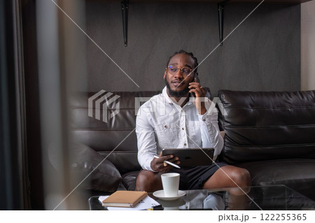 Young African American businessman dressed casually Work from your laptop while you're on vacation by working from home. 122255365