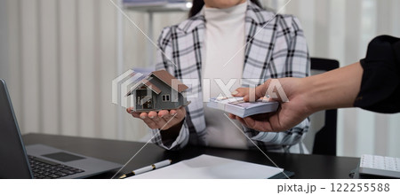 real estate broker Agents deliver sample homes and home contract documents to customers. Concept of buying and selling houses and getting real estate insurance. 122255588