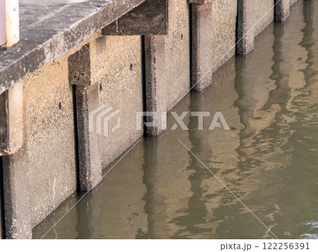 Urban dock photography close-up reflections of waterfront structures in a calm tranquil setting 122256391