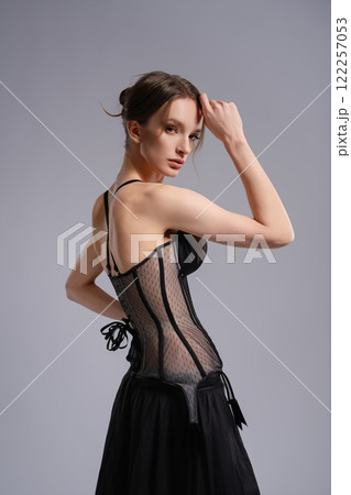 Elegant woman in stylish black corset lingerie posing indoors Elegant woman in stylish black corset lingerie posing indoors 122257053
