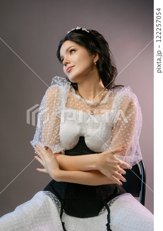 Elegant woman in corset and lingerie showcasing unique fashion style Elegant woman in corset and lingerie showcasing unique fashion style 122257054