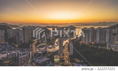 Urban Skyline at Sunset Overlooking Harbor and Mountains, HK Jan 12 2025 122257221