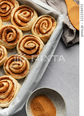 Delicious cinnamon rolls prepared for baking in a rectangular pan 122258455