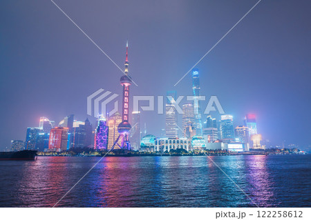 Cityscape view of Shanghai city at night. Skyscraper of Lujiazui in Pudong, view from The Bund of Shanghai, China. landmark and popular for tourism attractions. Travel and Vacation concept Cityscape view of Shanghai city at night. Skyscraper of Lujiazui in Pudong, view from The Bund of Shanghai, China. landmark and popular for tourism attractions. Travel and Vacation concept 122258612