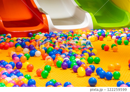 A colorful playground with vibrant slides and a lively ball pit for endless fun. 122259599