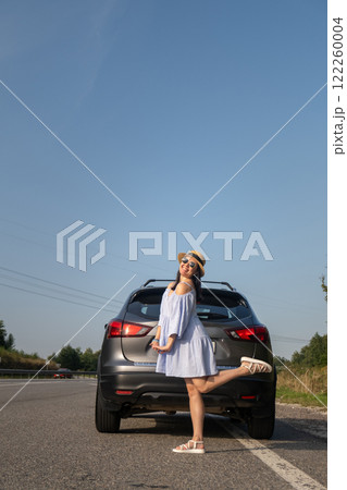 Cheerful Woman Posing by SUV on Sunny Day 122260004