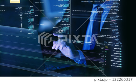 Close-up of hands on laptop keyboard, surrounded by floating, translucent layers of fictional code, representing virtual programming and system diagnostics. 122260317