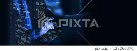 Close-up view of fictional code projected over typing hands, emphasizing interaction in virtual space between human creativity and digital technology. 122260370