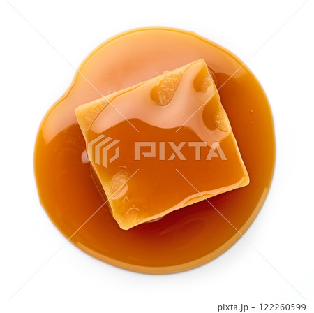 caramel candy in melted caramel sauce 122260599