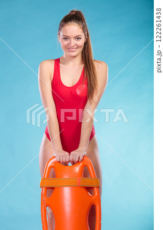 Lifeguard with rescue buoy supervising. Lifeguard with rescue buoy supervising. 122261438