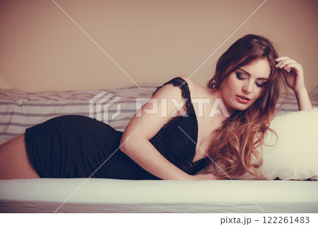 Seductive young woman in lingerie in bed. Seductive young woman in lingerie in bed. 122261483