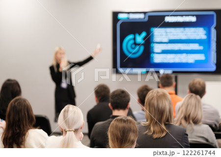 Speaker presenting to audience in a modern conference room setting Speaker presenting to audience in a modern conference room setting 122261744