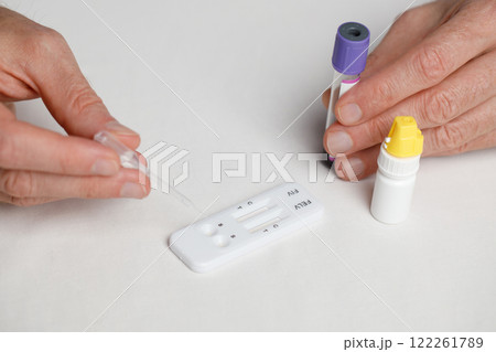 FIV and FeLV test kit. Male veterinarian practitioner doing medical sample rapid diagnostic test FIV and FeLV test kit. Male veterinarian practitioner doing medical sample rapid diagnostic test 122261789