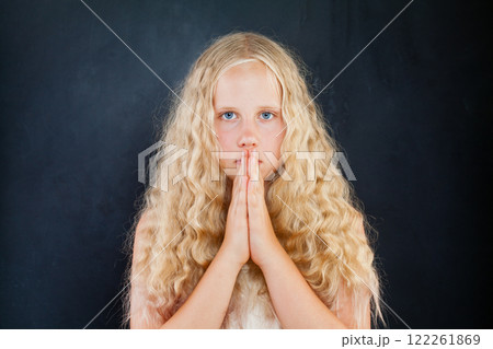 Child girl with hands folded in prayer concept for faith, spirituality and religion. 122261869