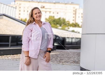 Happy Young Smiling Plus Size Woman outdoors on City Street at summer day. Portrait Beautiful Curvy model, Enjoying Active Lifestyle in Vibrant Urban, Body Positivity Happy Young Smiling Plus Size Woman outdoors on City Street at summer day. Portrait Beautiful Curvy model, Enjoying Active Lifestyle in Vibrant Urban, Body Positivity 122263395