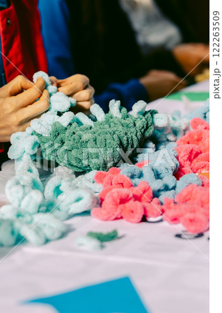 Close-up of female hands weaving carpet from colorful thick threads. Vertical video.Taken from hand. High quality photo Close-up of female hands weaving carpet from colorful thick threads. Vertical video.Taken from hand. High quality photo 122263509