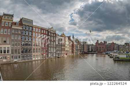 houses by a water canal in Amsterdam. houses by a water canal in Amsterdam. 122264524