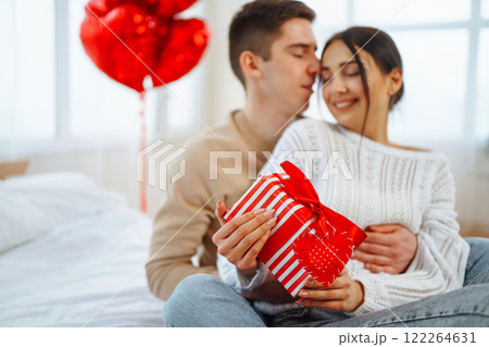 Exchange of gifts. Romantic day together. Valentines day, couple, relationships and people concept. Exchange of gifts. Romantic day together. Valentines day, couple, relationships and people concept. 122264631