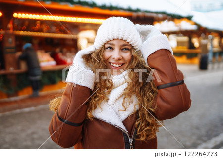Happy woman posing at a festive street market. Holiday concept, relaxation. Happy woman posing at a festive street market. Holiday concept, relaxation. 122264773