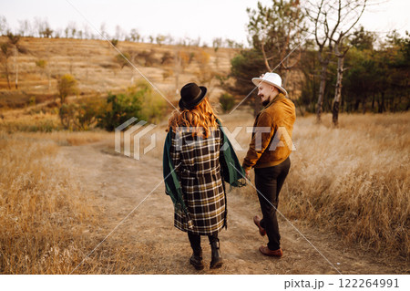 Lovely hipster couple enjoying each other in the autumn park. Nice autumn day. love and lifestyle. Lovely hipster couple enjoying each other in the autumn park. Nice autumn day. love and lifestyle. 122264991