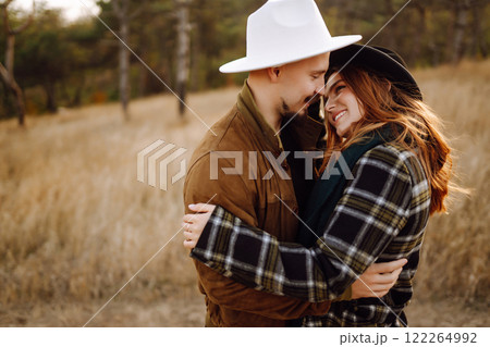 Lovely hipster couple enjoying each other in the autumn park. Nice autumn day. love and lifestyle. Lovely hipster couple enjoying each other in the autumn park. Nice autumn day. love and lifestyle. 122264992