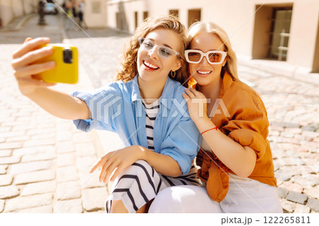 Young friends having fun and take selfie on the phone together. Entertainment, youth concept. Young friends having fun and take selfie on the phone together. Entertainment, youth concept. 122265811