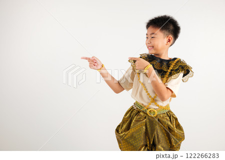 Portrait Thailand kid boy smiling traditional Thai dress costume indicate finger empty space, studio isolated white background, primary child pointing index out with copy space Portrait Thailand kid boy smiling traditional Thai dress costume indicate finger empty space, studio isolated white background, primary child pointing index out with copy space 122266283