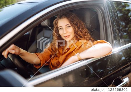 Stylish woman driving car. Traveler is the driver. Automobile travel. Sharing car. Lifestyle concept Stylish woman driving car. Traveler is the driver. Automobile travel. Sharing car. Lifestyle concept 122266802