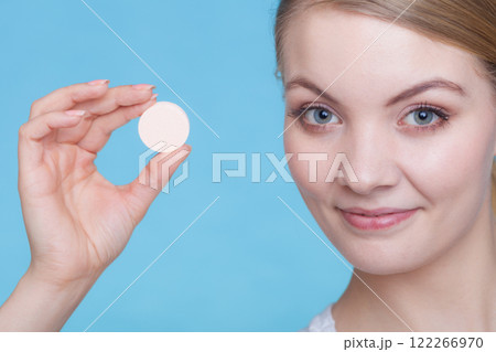 Woman hand holding big effervescent pill 122266970