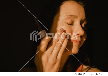 Beautiful white European baby face young woman applying serum from an eyedropper. Facial skin care cosmetic. Daily routine, self-care. Beauty tools. Beautiful white European baby face young woman applying serum from an eyedropper. Facial skin care cosmetic. Daily routine, self-care. Beauty tools. 122267398