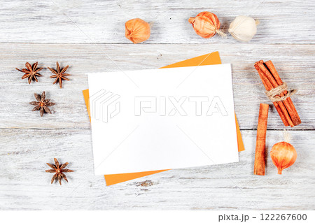 Blank white card mockup with dried anise stars and cinnamon sticks 122267600