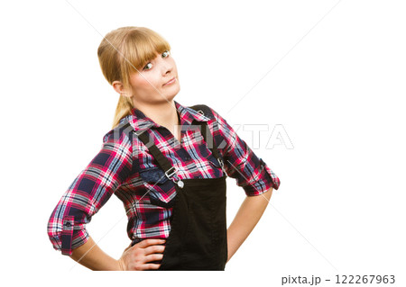 Surprised woman wearing dungarees and check shirt 122267963