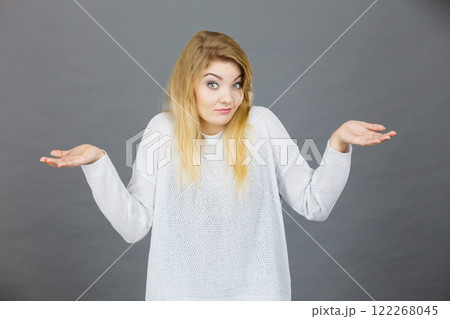 Confused young blonde woman gesturing with hands Confused young blonde woman gesturing with hands 122268045